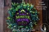 a wreath with the text "Welcome to Monster Manor" and a spooky castle design, surrounded by green foliage.