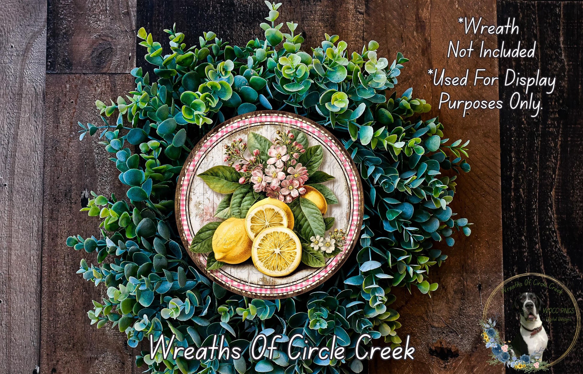 A wreath made of green leaves and flowers, with a circular arrangement of lemons and other fruits, and a decorative border.