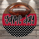 A football is displayed on a wooden surface, with the text "game day" written in a stylized font below it.