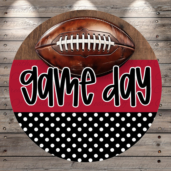 A football is displayed on a wooden surface, with the text "game day" written in a stylized font below it.