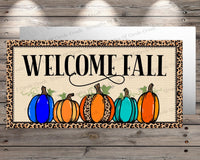 a welcome fall sign with pumpkins on it