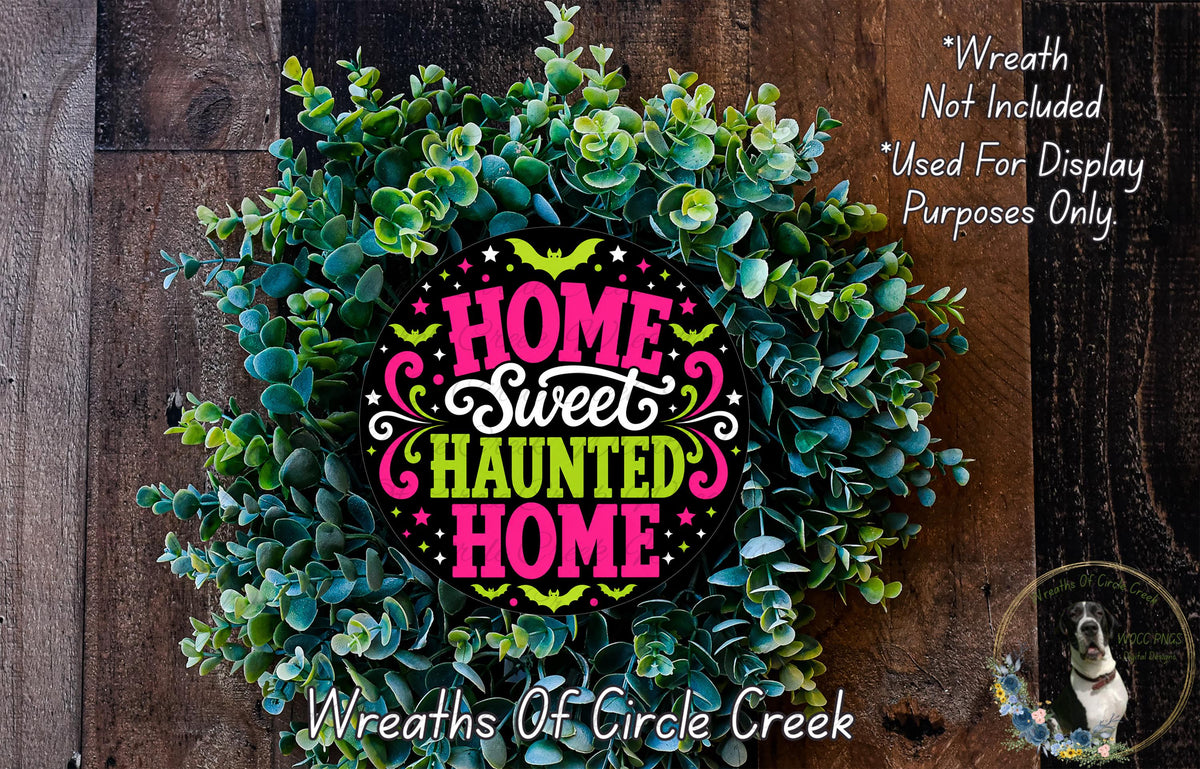a wreath made of green leaves and flowers, with a colorful design that says "Home Sweet Haunted Home".