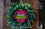 a wreath made of green leaves and flowers, with a colorful design that says "Home Sweet Haunted Home".