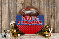 a decorative sign with a football and the words "tailgates & touchdowns" written on it, placed on a wooden surface.