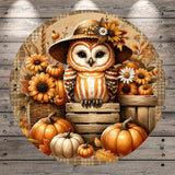 A whimsical illustration of an owl wearing a hat and surrounded by autumn-themed elements, including pumpkins, flowers, and a wooden crate.
