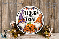 a Halloween-themed sign with a pumpkin and two gnomes, surrounded by flowers and a wooden background.