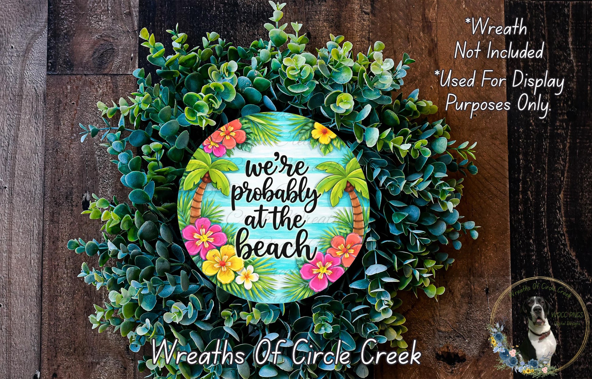 A wreath made of various green plants and flowers, with a circular sign in the center that says "we're probably at the beach".