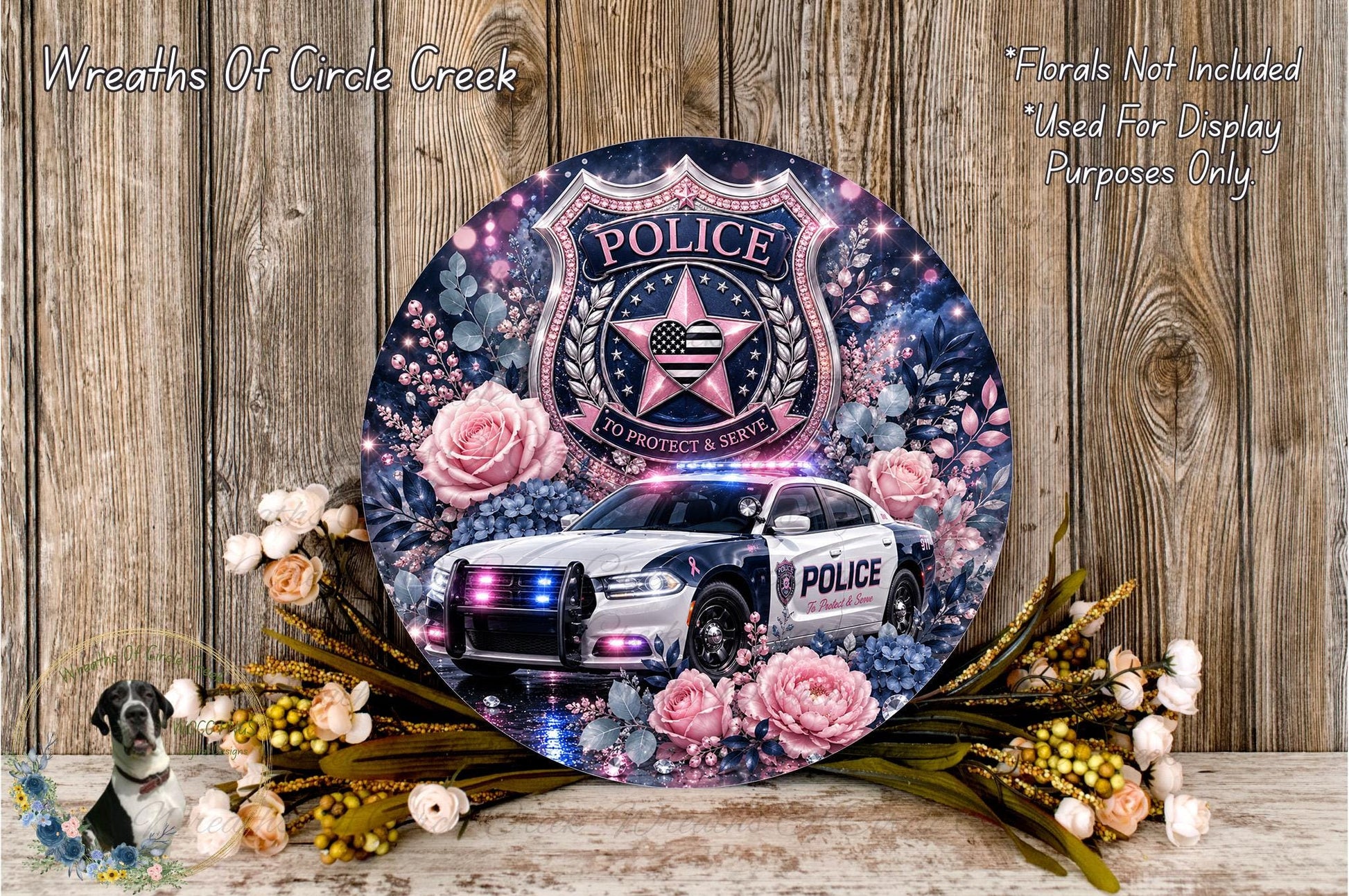 A decorative police car with a floral design, surrounded by flowers and foliage, and a shield-shaped emblem with the word "POLICE" on it.