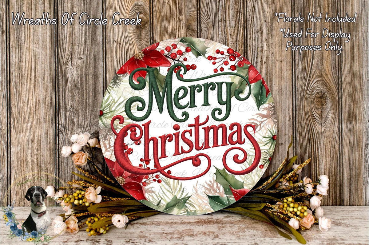 A festive Christmas wreath with the text "Merry Christmas" displayed prominently. The wreath is surrounded by various holiday decorations, including flowers and greenery, and is placed on a wooden surface.