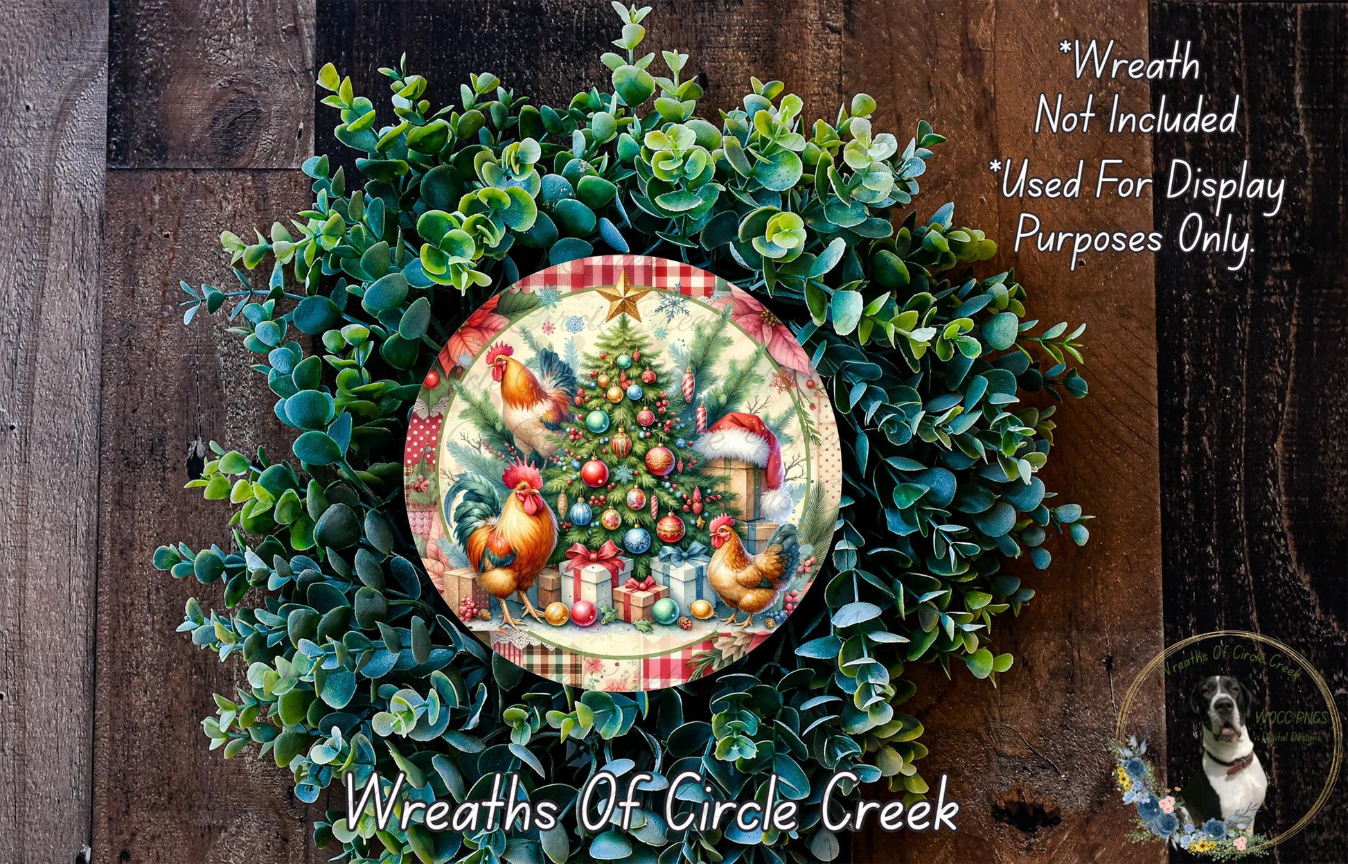 A wreath made of green foliage and featuring a Christmas tree with ornaments, including a rooster and a dog, is displayed on a wooden surface.