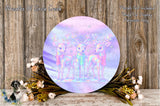 a circular wreath with three deer on it, surrounded by flowers and placed on a wooden surface.