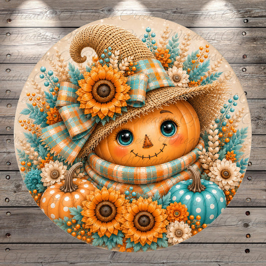 A round, decorative pumpkin with a face, surrounded by flowers, a plaid hat, and a straw hat.