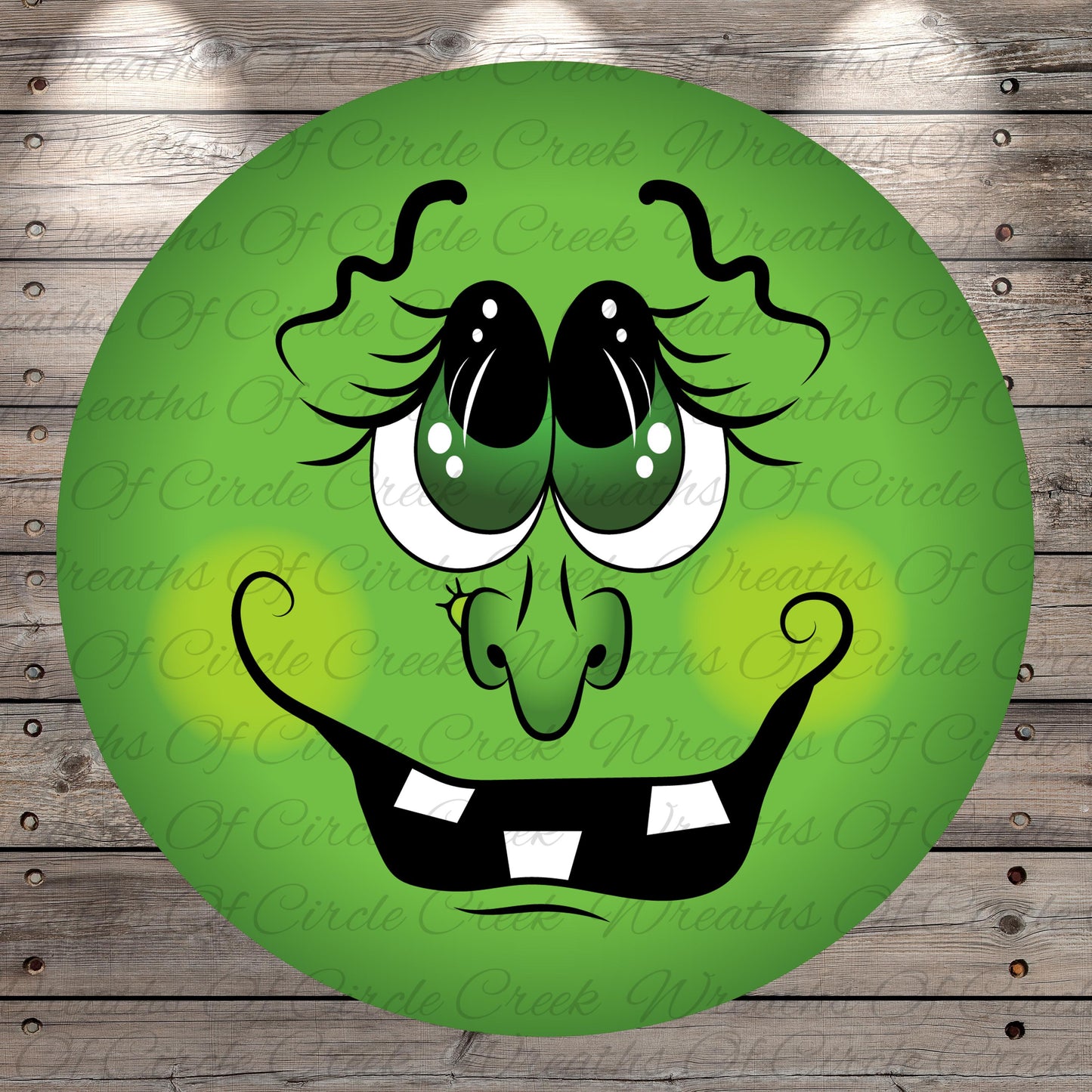 A green, round, cartoonish face with large eyes, a big smile, and a small nose is displayed against a wooden background.