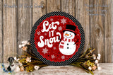 A decorative snowman sign with the text "Let It Snow" is displayed on a wooden surface, surrounded by flowers and greenery.