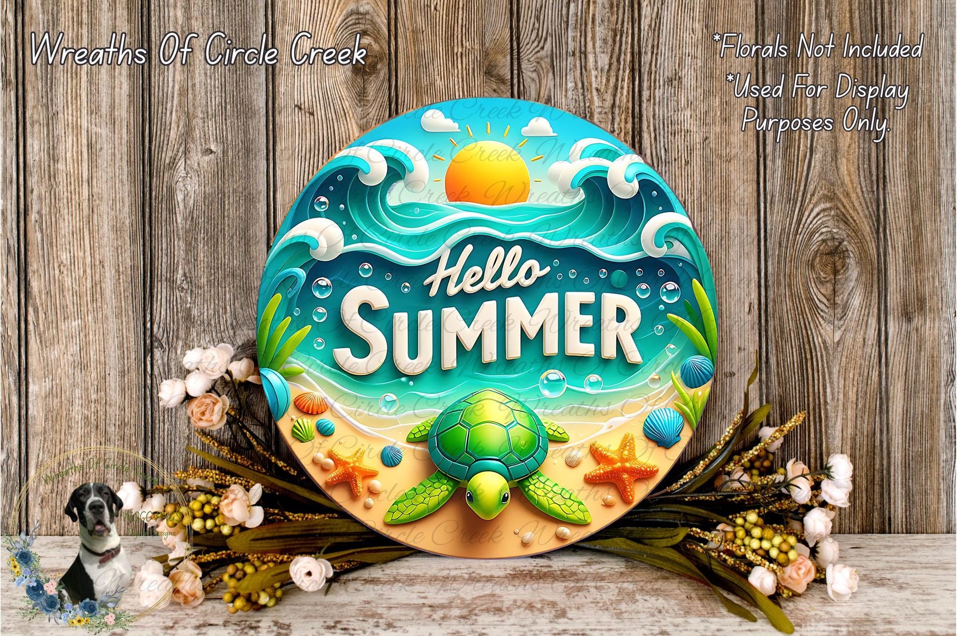 A decorative sign with the text "Hello Summer" surrounded by various summer-themed elements such as a turtle, seashells, and flowers. The sign is placed on a wooden surface, and there are some flowers and greenery around it.
