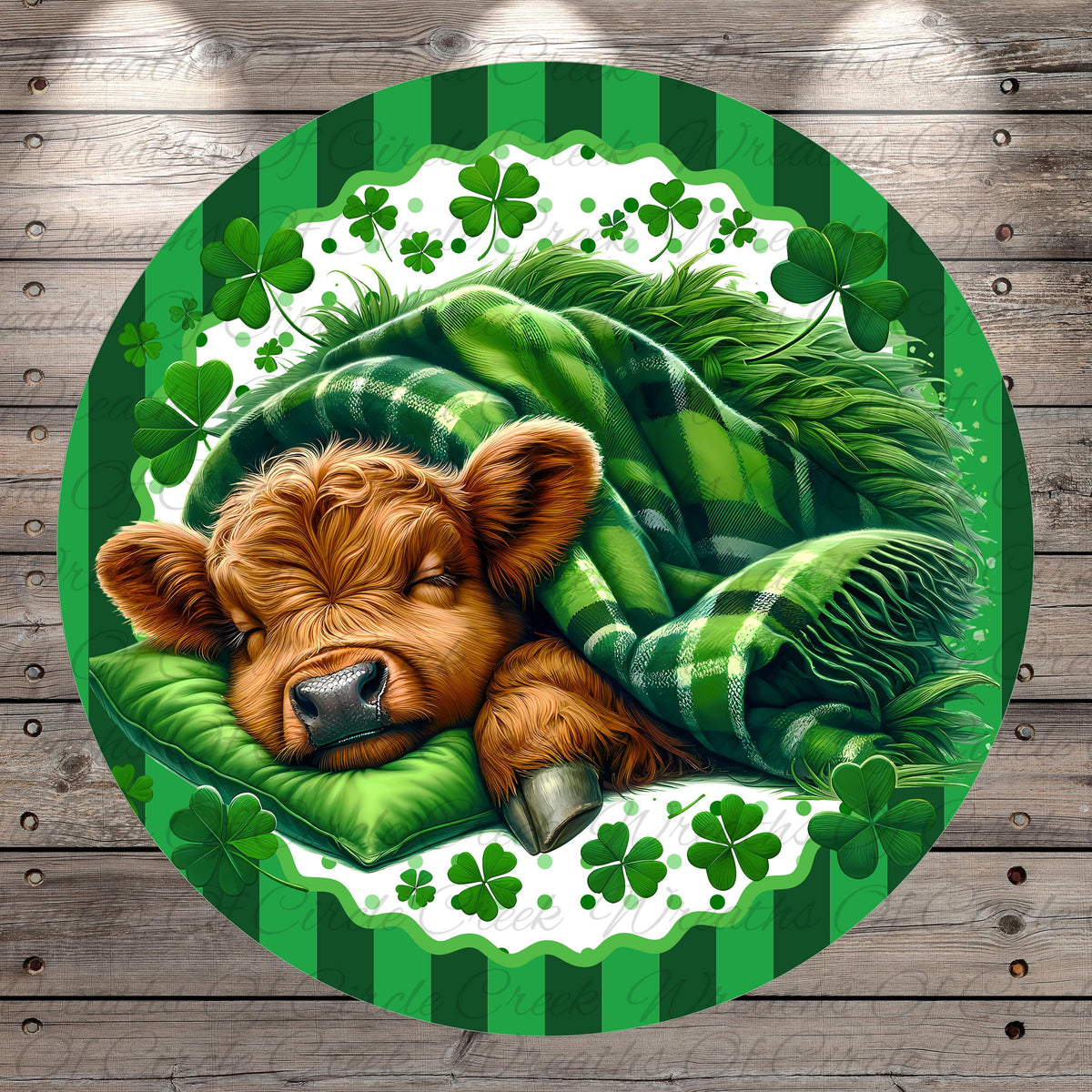 A brown cow is peacefully sleeping on a green blanket, surrounded by shamrocks and a green and white striped border.