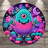 A colorful, whimsical monster with a large eye and sharp teeth is surrounded by various Halloween-themed elements, including pumpkins, bats, and stars, all set against a starry night sky background.