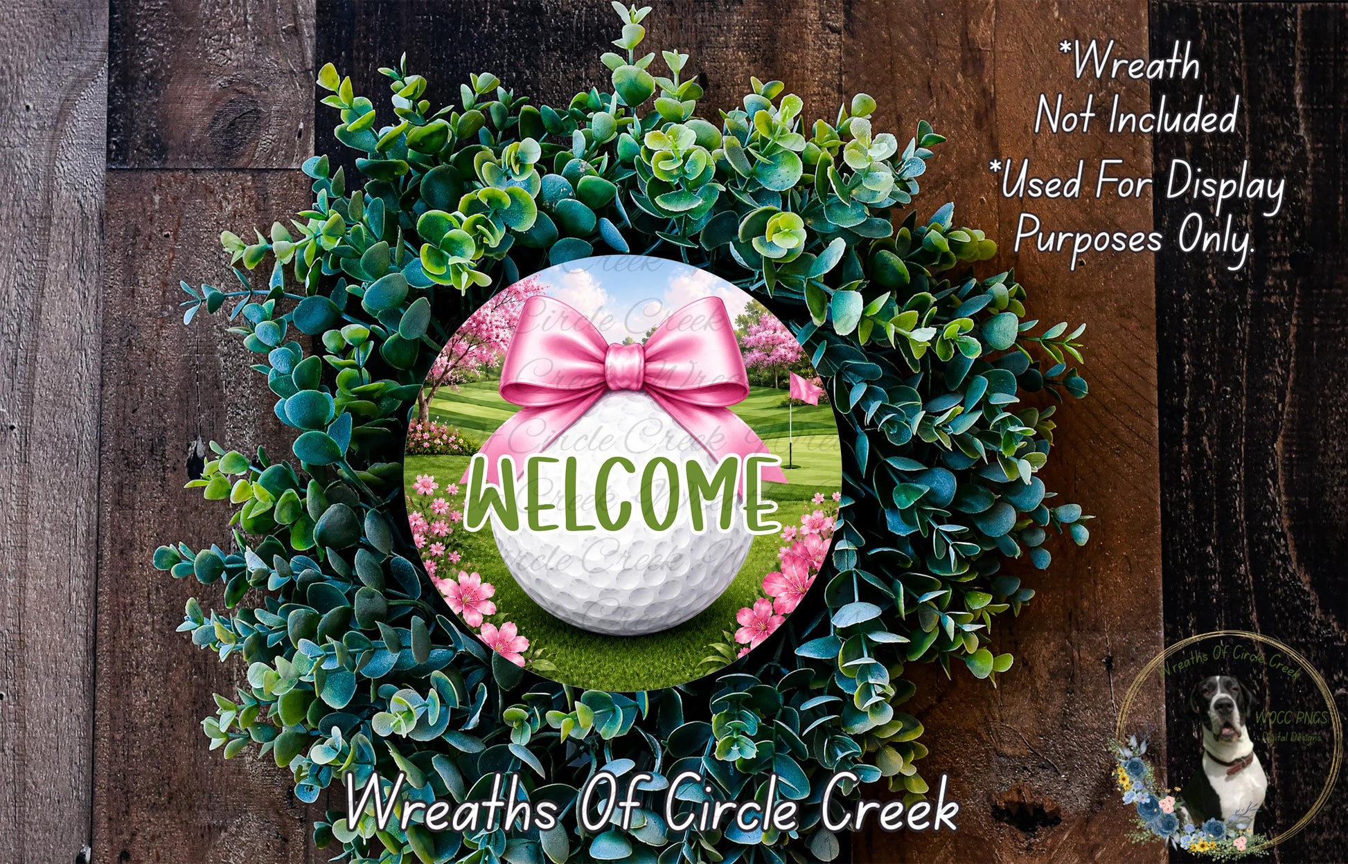 a wreath with a golf ball and a pink bow, surrounded by greenery and flowers, with the word "WELCOME" prominently displayed.