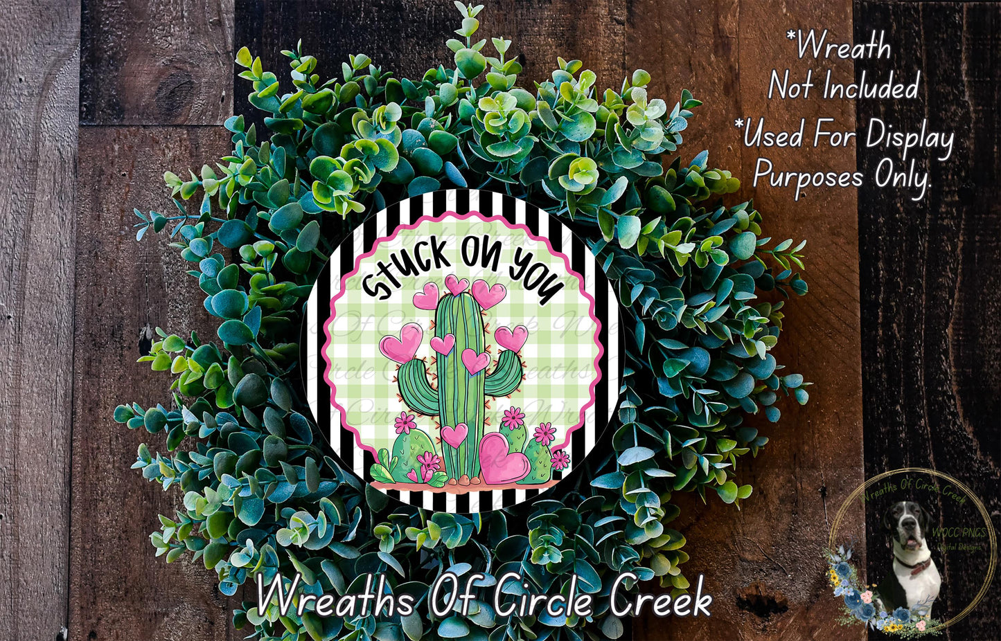 a wreath made of green leaves and a cactus with pink hearts, accompanied by a sign that says "Stuck on You".
