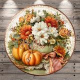 A decorative round plate with a floral arrangement of orange and white flowers, along with two pumpkins and a red and white checkered ribbon. The word "Hello" is written in cursive on the plate.