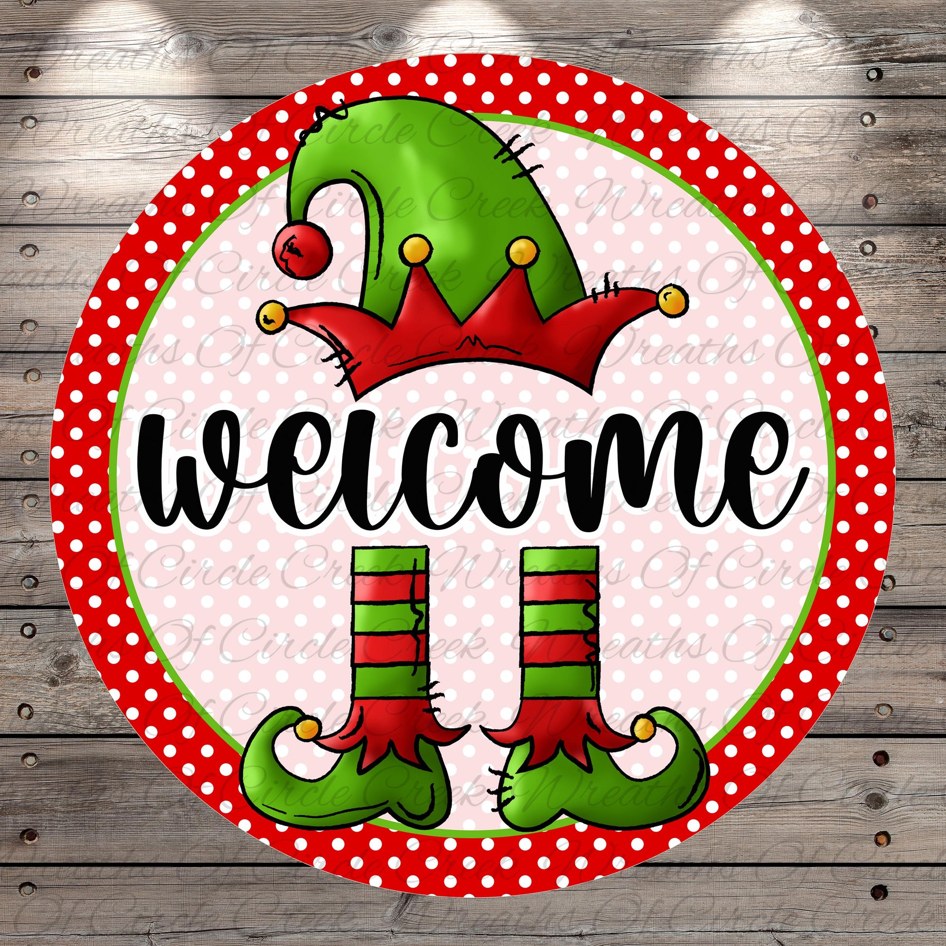 A circular sign featuring a green elf hat, red and green striped boots, and the word "welcome" written in a cursive font.
