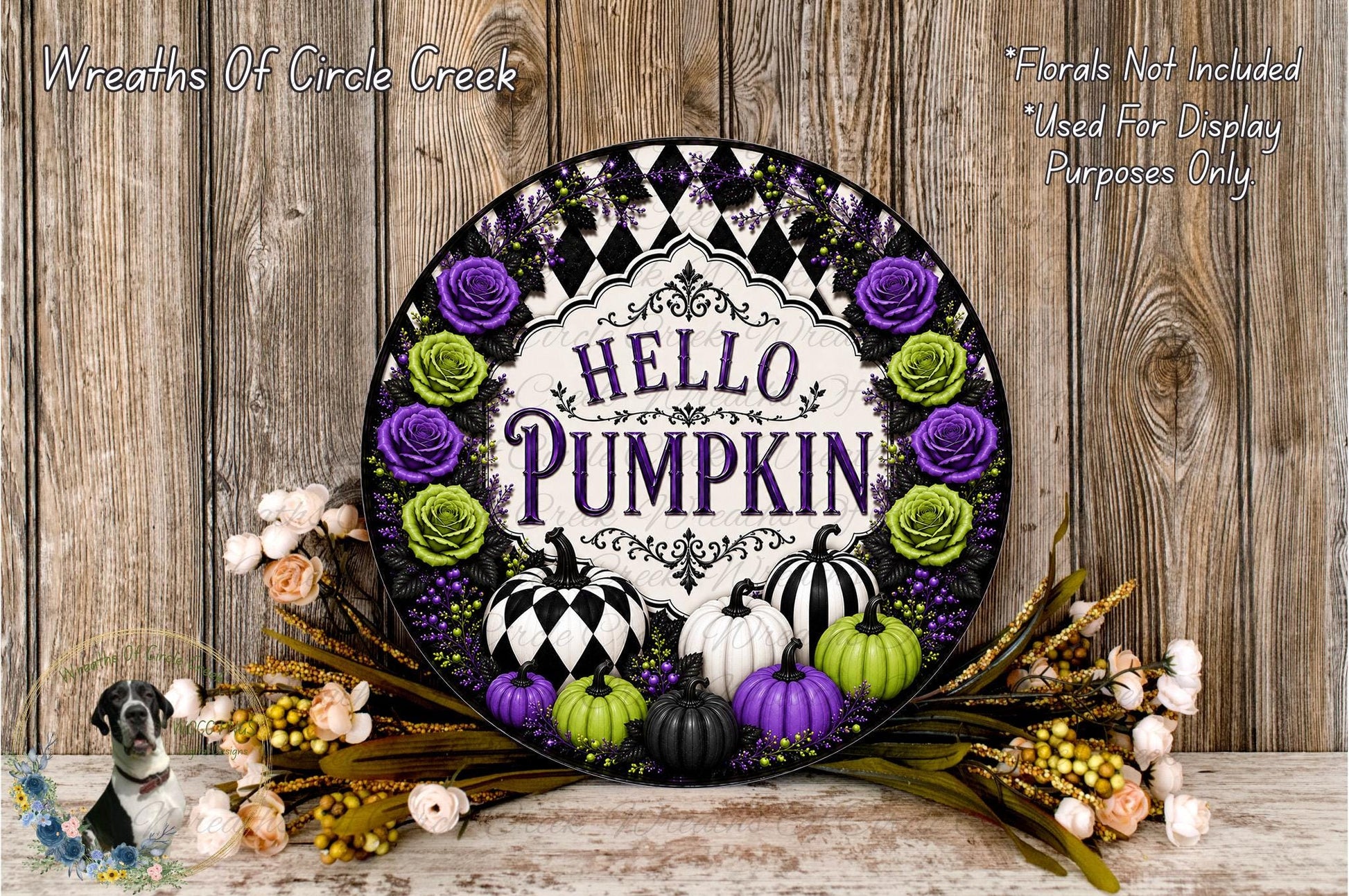 a decorative wreath with the text "HELLO PUMPKIN" surrounded by various fall-themed elements such as pumpkins, roses, and other seasonal decorations. The wreath is displayed on a wooden surface, and there are additional fall-themed elements like flowers and leaves scattered around it.