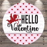 A circular graphic with a red cherub holding a bow and arrow, surrounded by a pattern of red hearts on a pink background. The text "Hello Valentine" is displayed prominently in the center of the image.