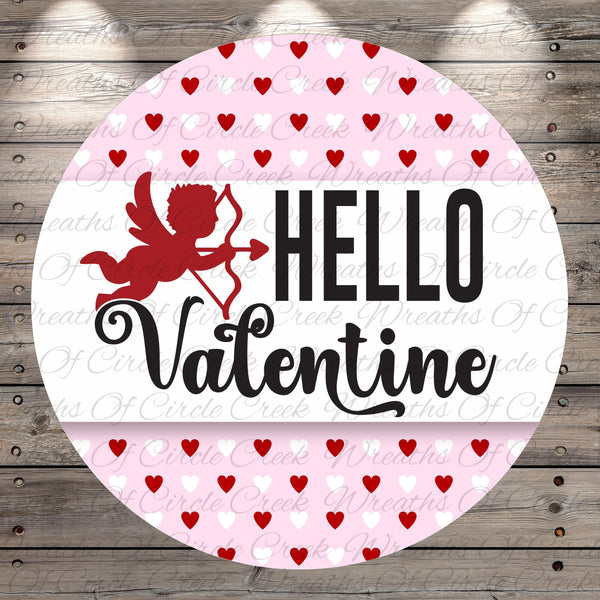 A circular graphic with a red cherub holding a bow and arrow, surrounded by a pattern of red hearts on a pink background. The text "Hello Valentine" is displayed prominently in the center of the image.