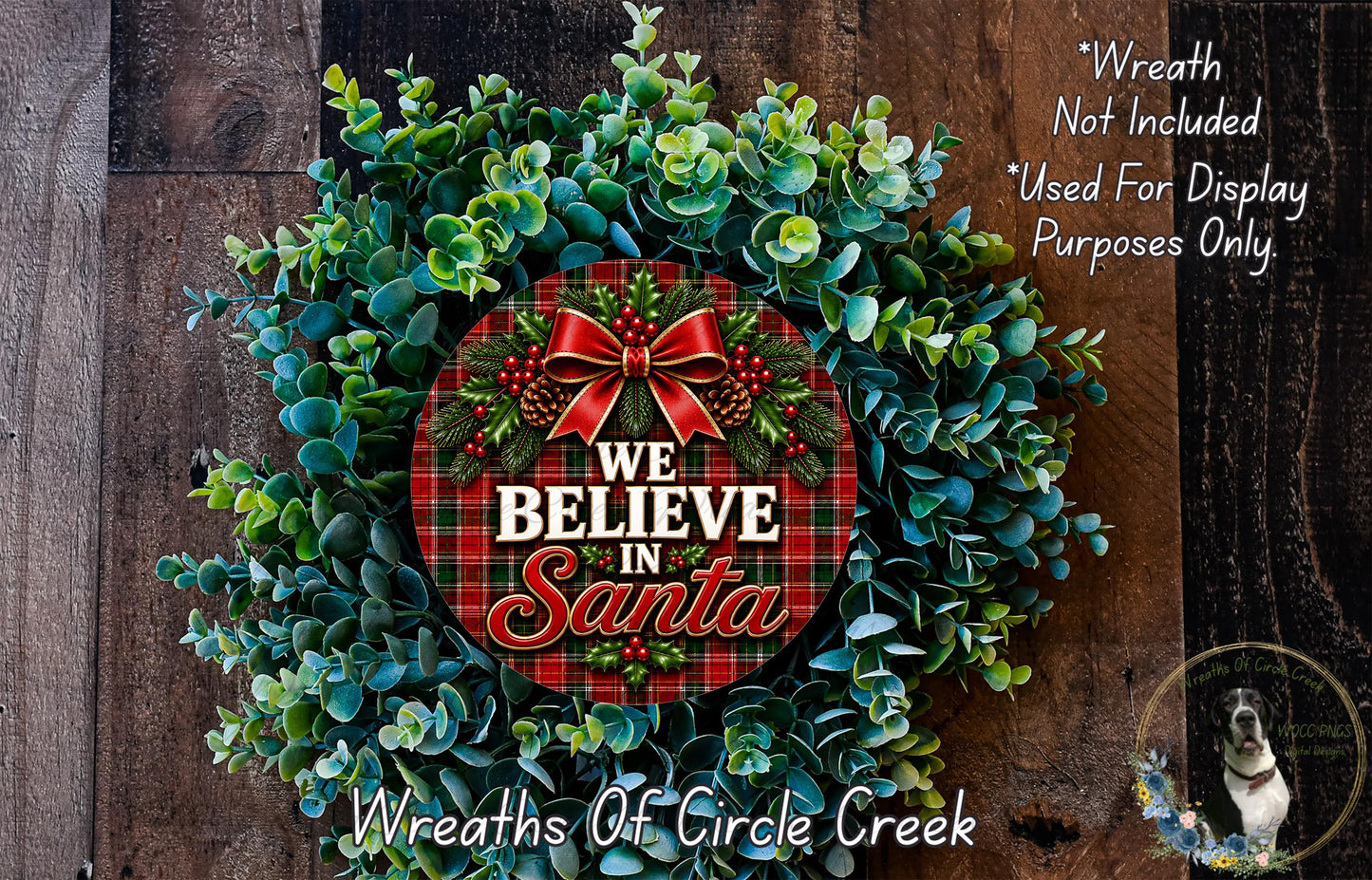 A festive Christmas wreath made of evergreen branches and a red bow, with the text "We Believe in Santa" displayed on it.