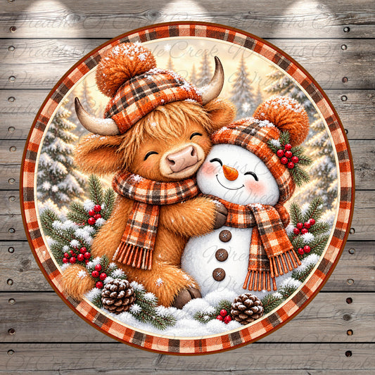 A cheerful winter scene featuring a cow and a snowman, both wearing plaid scarves and hats, surrounded by pine trees and berries.