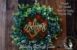 A wreath made of green and red foliage, with a red and gold welcome sign in the center. The wreath is displayed on a wooden surface, and there is a text overlay that reads "Welcome Wreath Not Included * Used For Display Purposes Only".