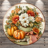 A round, decorative plate featuring a vibrant autumnal arrangement of flowers, pumpkins, and other seasonal elements.