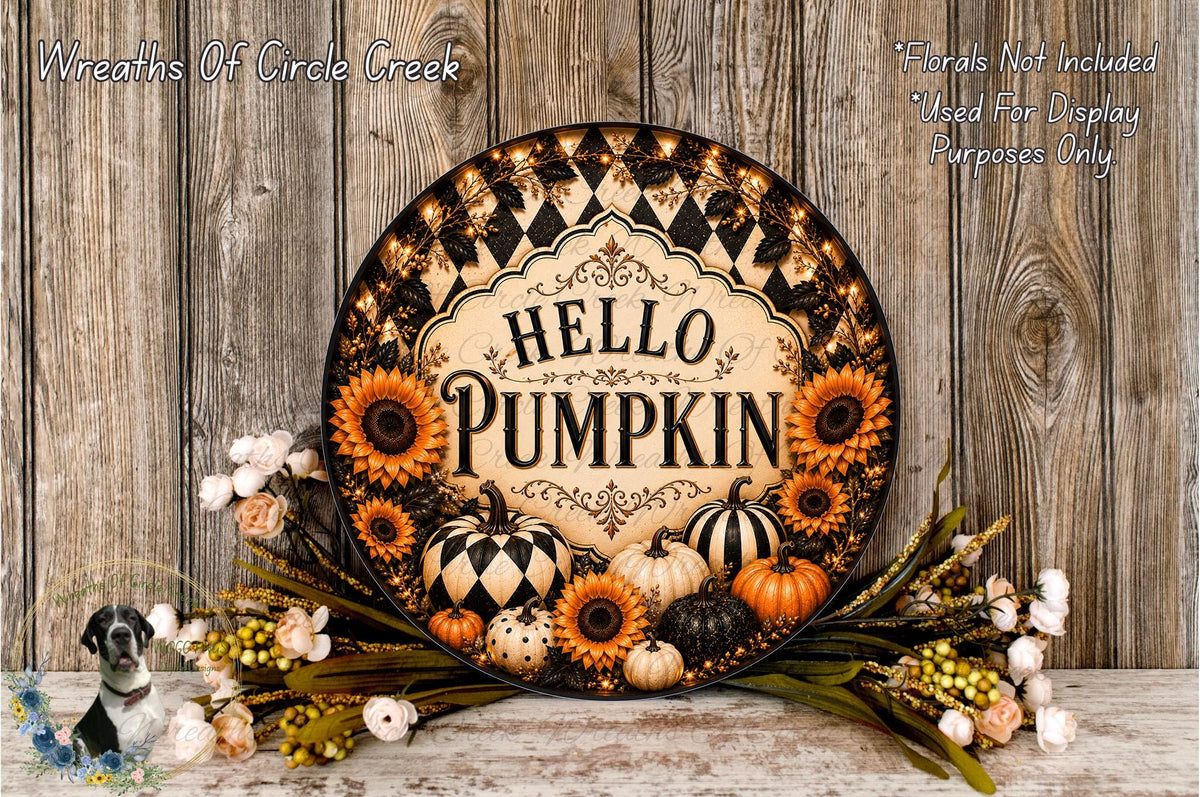A decorative wreath with the text "HELLO PUMPKIN" and various fall-themed elements such as sunflowers, pumpkins, and gourds. The wreath is displayed on a wooden surface, surrounded by flowers.