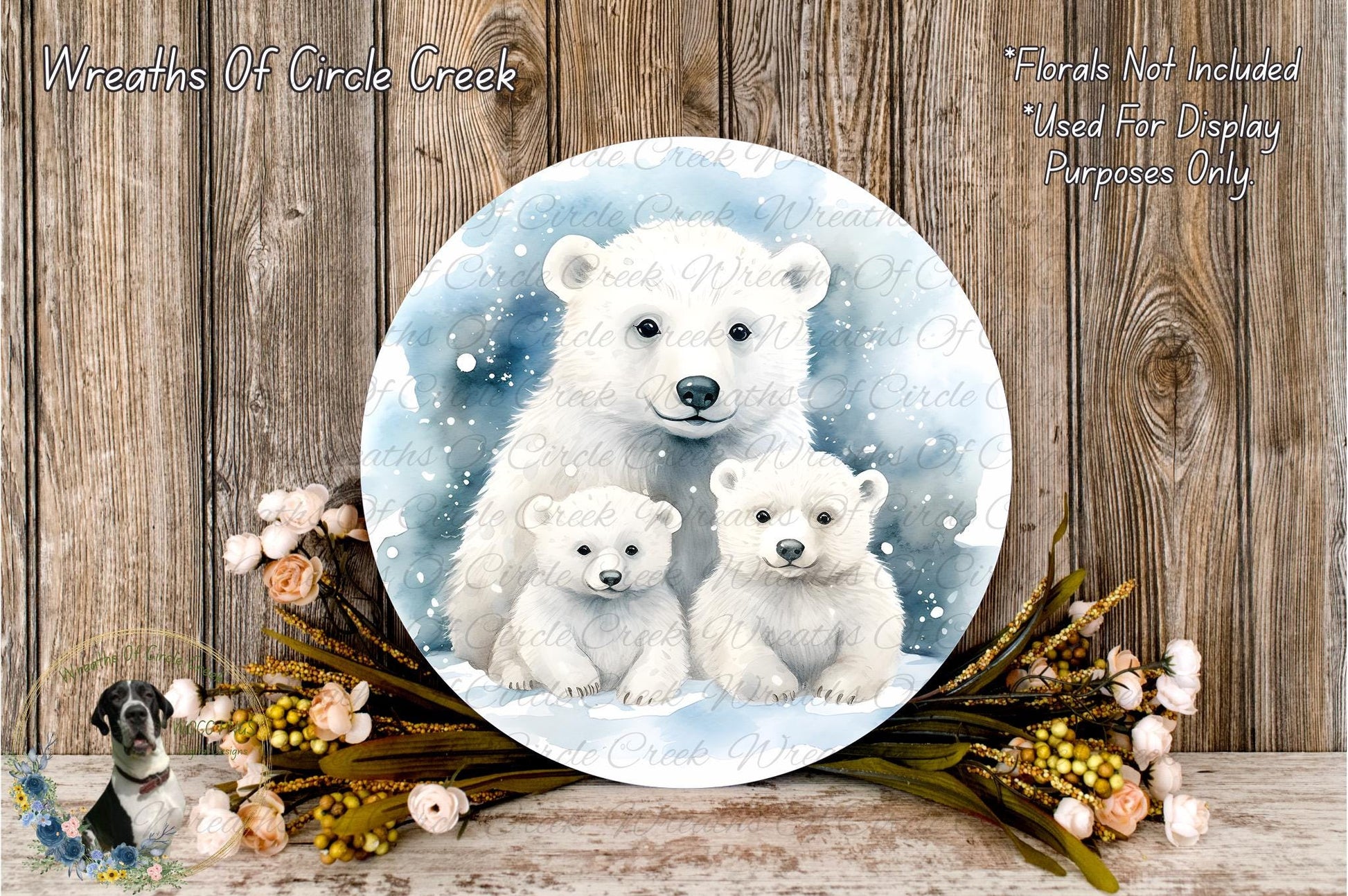 A circular wreath with a white polar bear and two baby polar bears, surrounded by a floral arrangement and a wooden background.