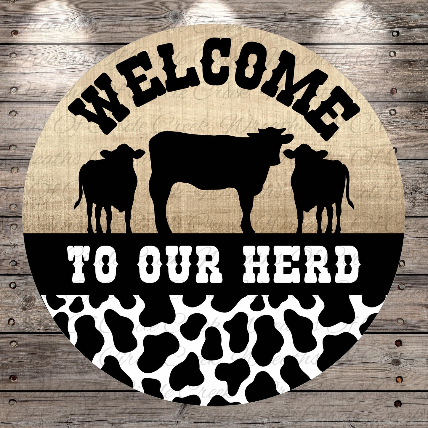 a circular sign with the text "Welcome to our herd" and silhouettes of three cows.