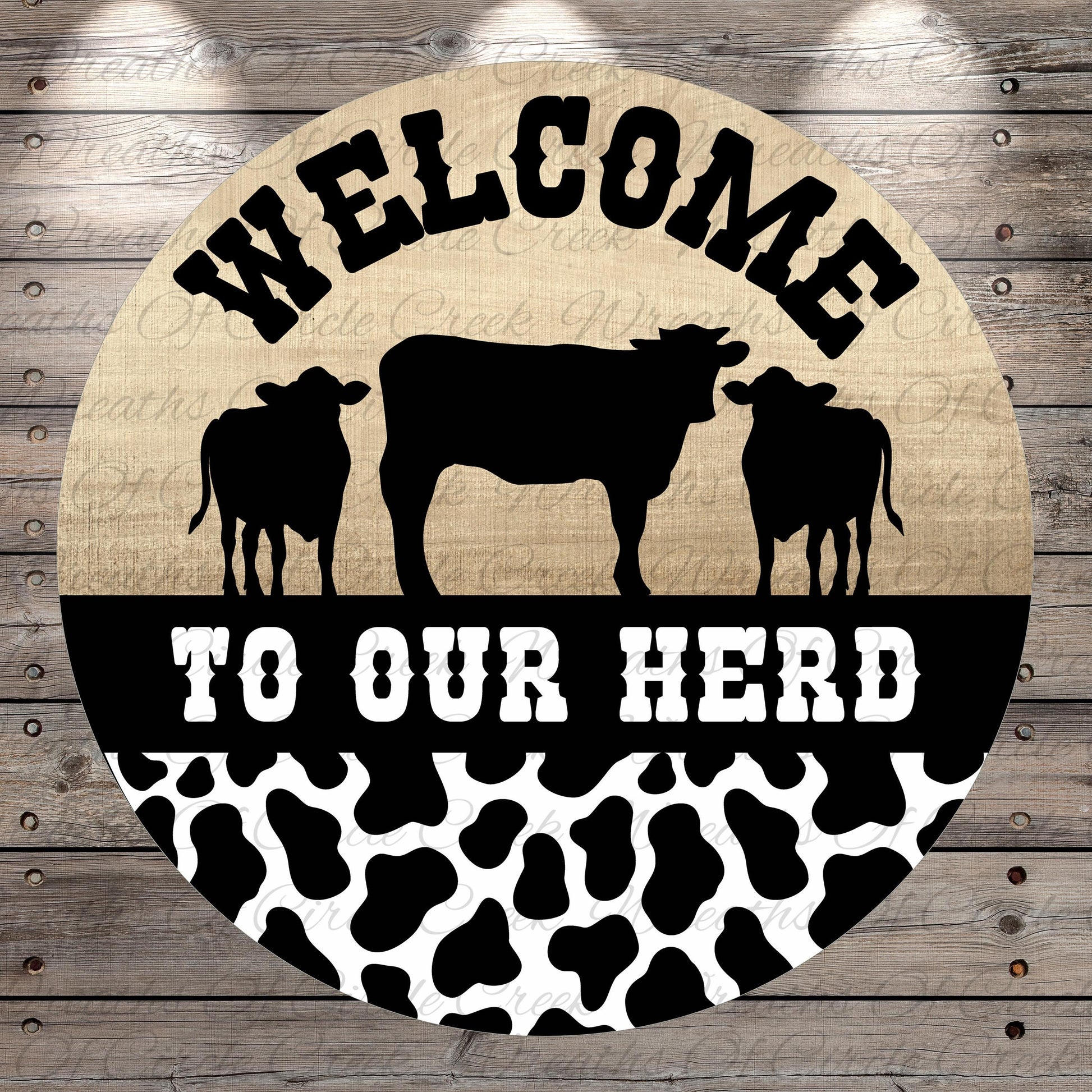 a circular sign with the text "Welcome to our herd" and silhouettes of three cows.