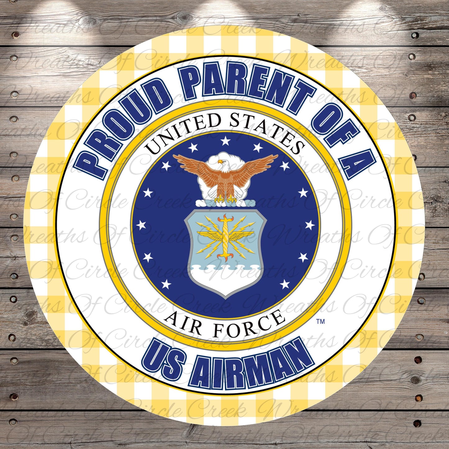 a circular emblem with the text "Proud Parent of a US Airman" and the Air Force seal, surrounded by a yellow and white checkered border.