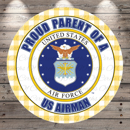 a circular emblem with the text "Proud Parent of a US Airman" and the Air Force seal, surrounded by a yellow and white checkered border.