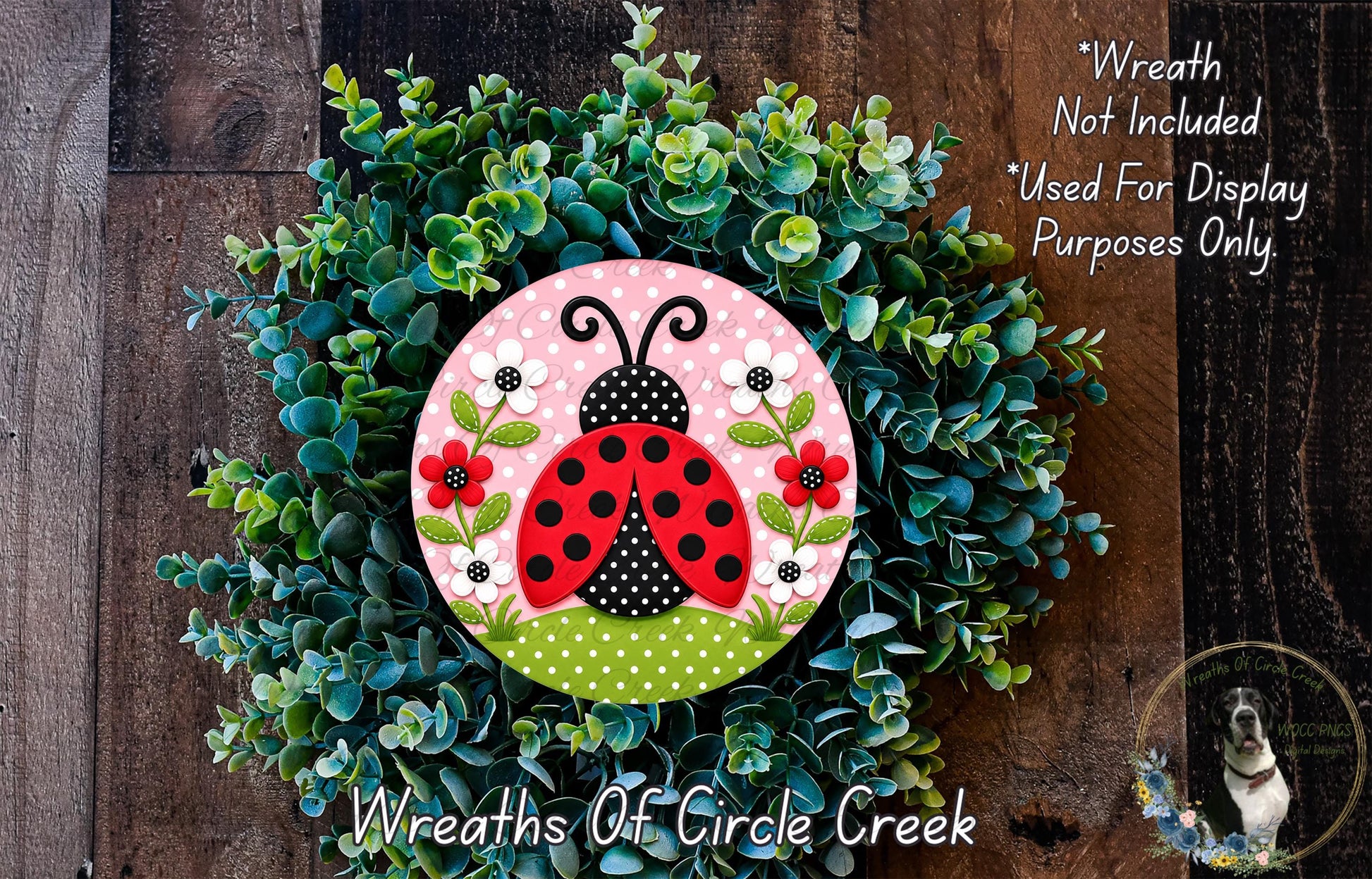 A wreath made of green foliage and flowers, with a red and black ladybug design in the center.