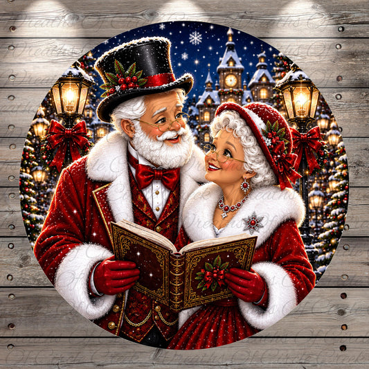 Santa Claus and his reindeer are reading a book together in front of a snowy village, with Christmas lights and trees in the background.