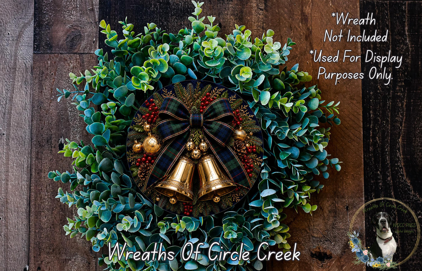 A wreath made of green leaves, red berries, and gold bells, with a plaid bow and a dog in the background.