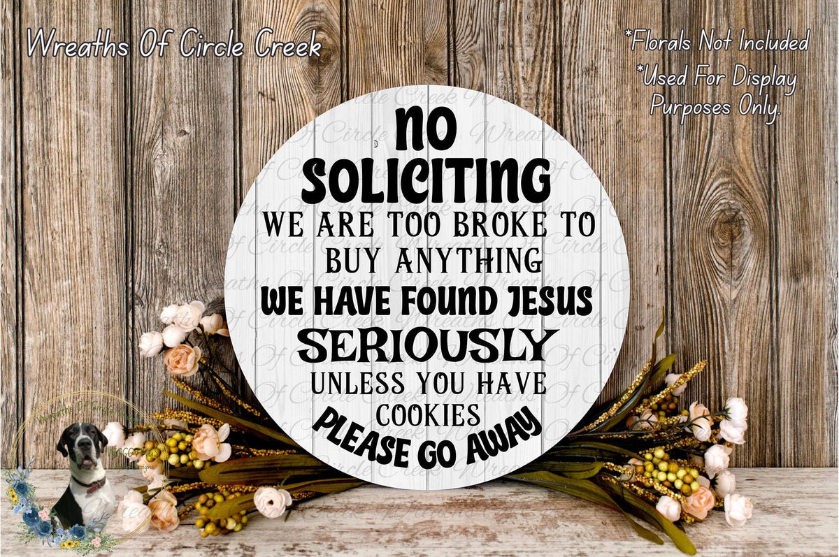 a sign with a humorous message, surrounded by flowers and a wooden background.