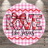 A circular design with a pink and white checkered background, featuring the text "LOVE like Jesus" in a stylized font.