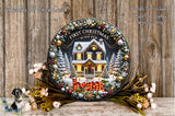 A decorative Christmas wreath with a house and trees, surrounded by flowers and other holiday decorations, placed on a wooden surface.