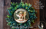 a wreath with a central design of a smiling angel holding a lit candle, surrounded by a lush green plant. The wreath is labeled "Happy Birthday Jesus" and is described as a "Wreath of Circle Creek".