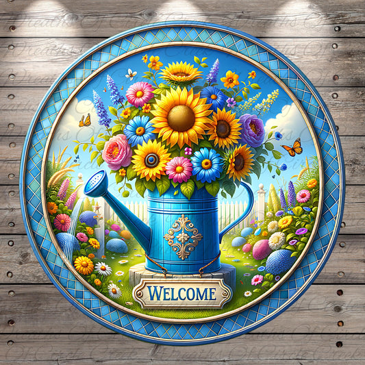 A blue watering can filled with a vibrant bouquet of flowers, including sunflowers, daisies, and other colorful blooms, is displayed on a blue circular plaque with the word "Welcome" written on it.