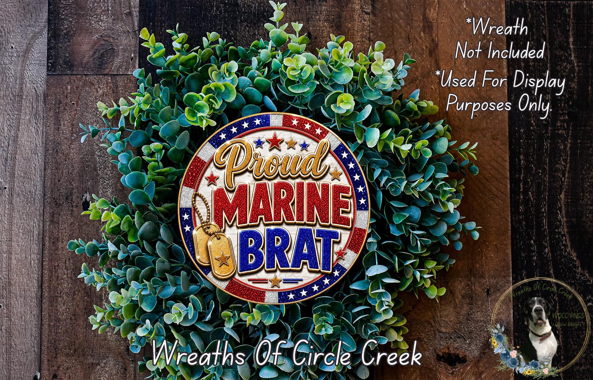a wreath made of green leaves and a circular emblem with the text "Proud Marine Brat" on it, placed on a wooden surface.