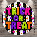 A colorful and playful design featuring the text "TRICK OR TREAT" surrounded by various shapes and colors, including circles, dots, and stripes.