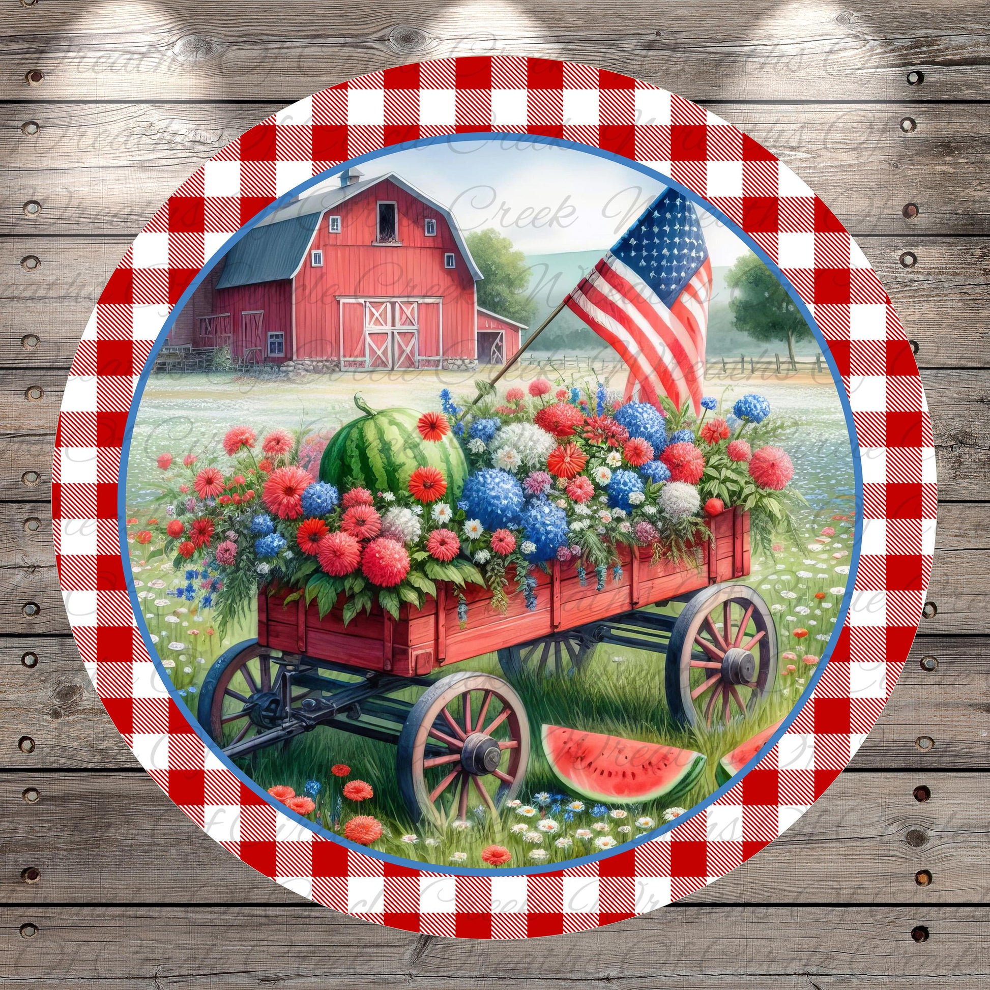 A red wagon filled with a variety of colorful flowers and plants is parked in front of a red barn, with an American flag flying in the background.