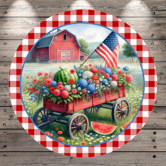 A red wagon filled with a variety of colorful flowers and plants is parked in front of a red barn, with an American flag flying in the background.